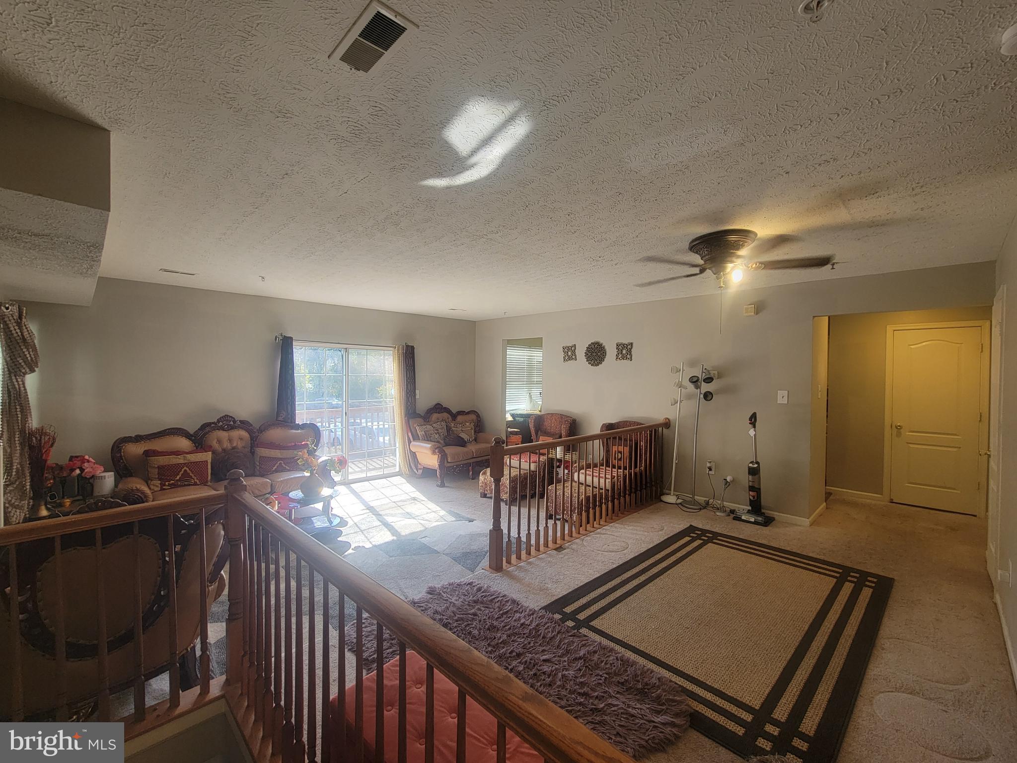 4634 Deepwood Court, Unit 89E Bowie, MD 20720 - Photo 8 of 29 a living room with furniture and a chandelier