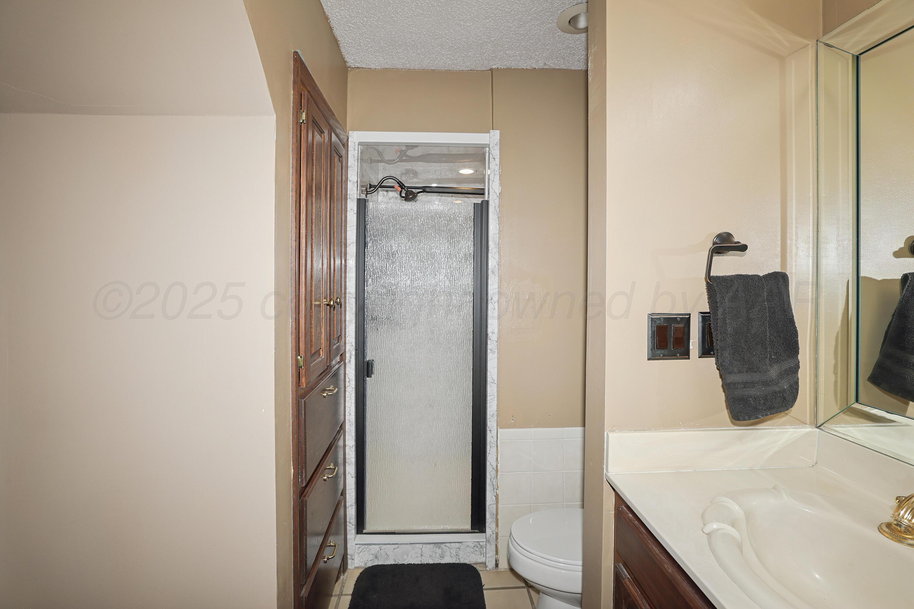 13901 Tangle Aire Point Amarillo, TX 79118 - Photo 19 of 55 a bathroom with a granite countertop sink and a mirror