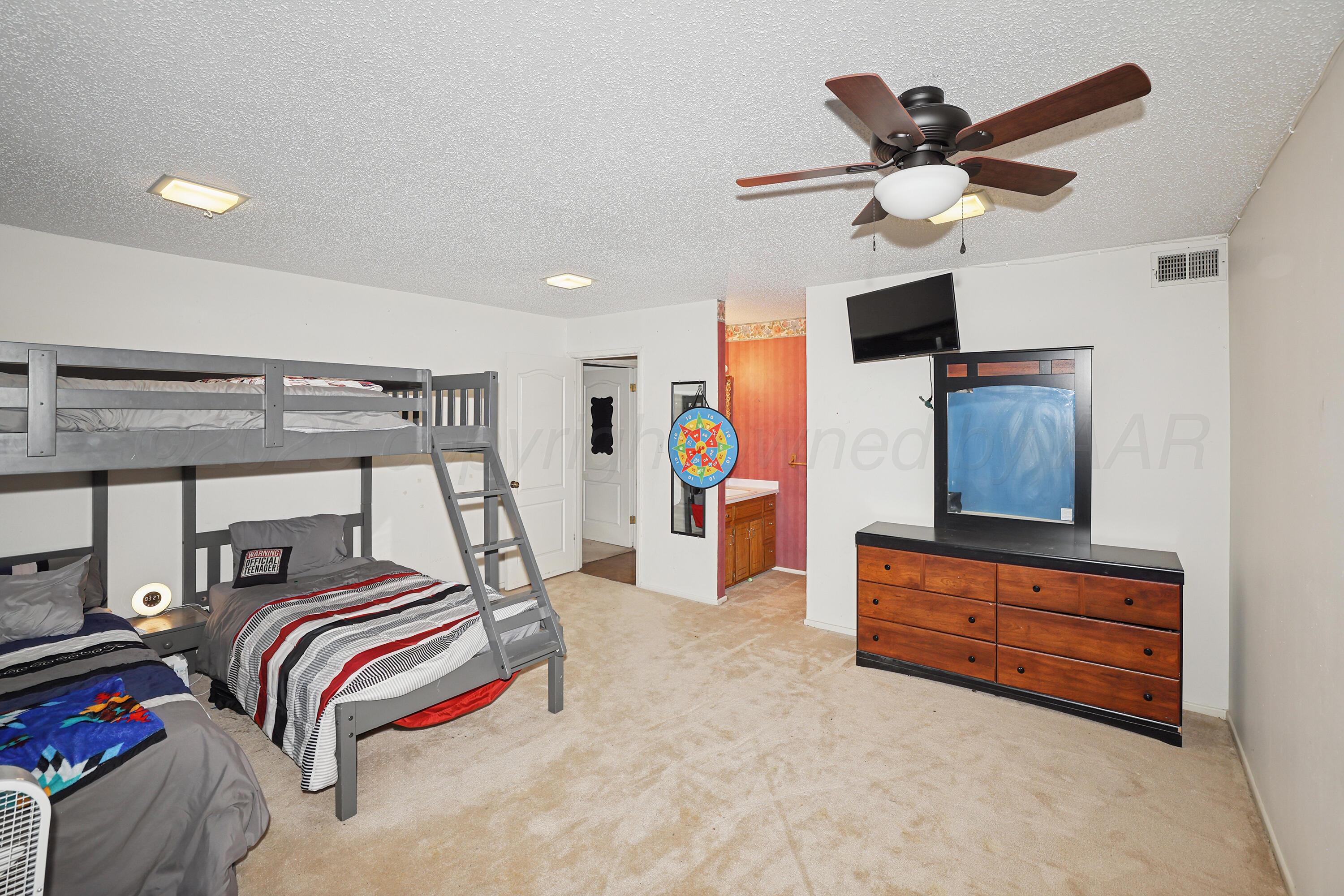 13901 Tangle Aire Point Amarillo, TX 79118 - Photo 24 of 55 a bedroom with furniture and a ceiling fan