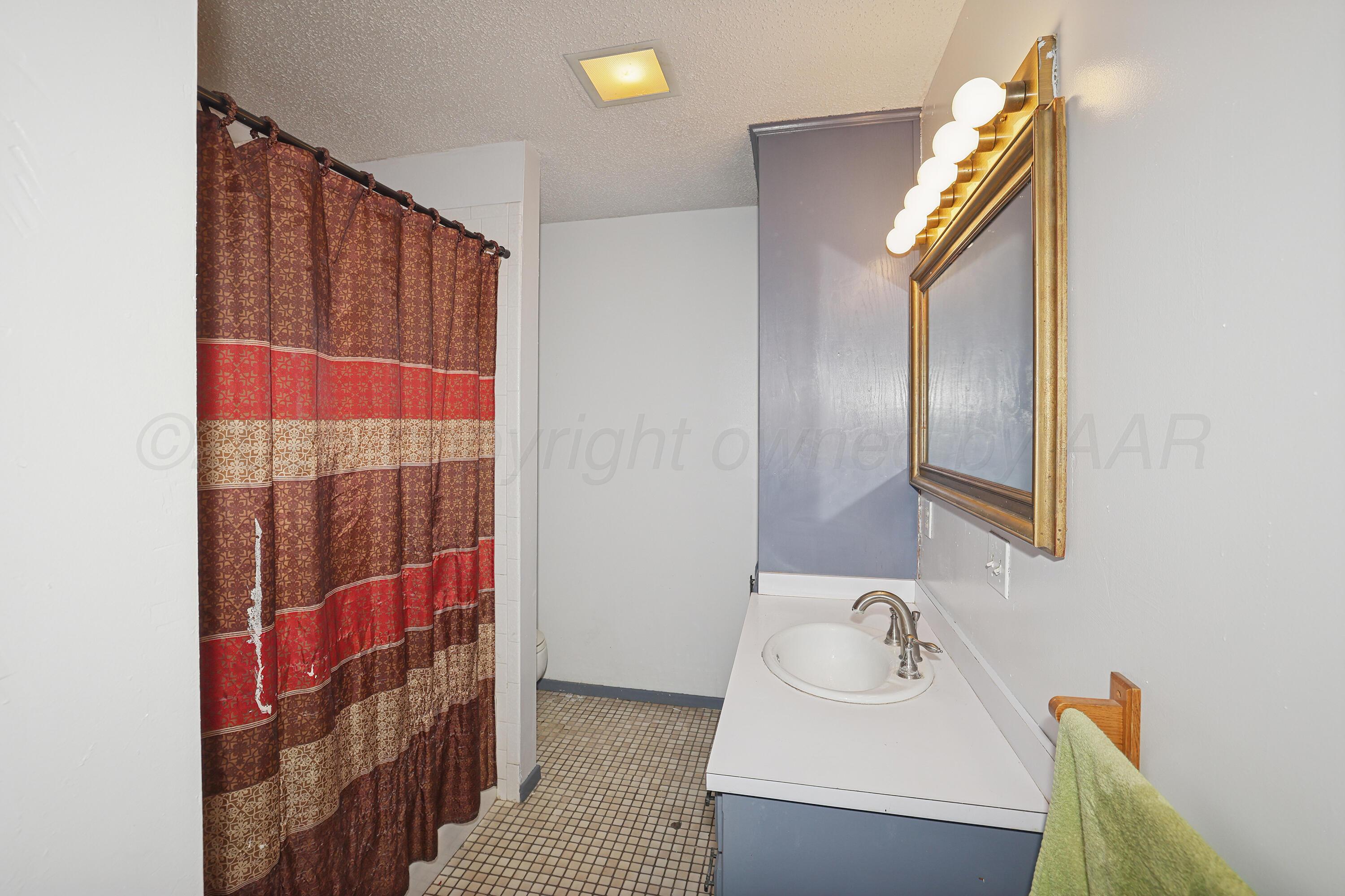 13901 Tangle Aire Point Amarillo, TX 79118 - Photo 27 of 55 a bathroom with a sink and a mirror