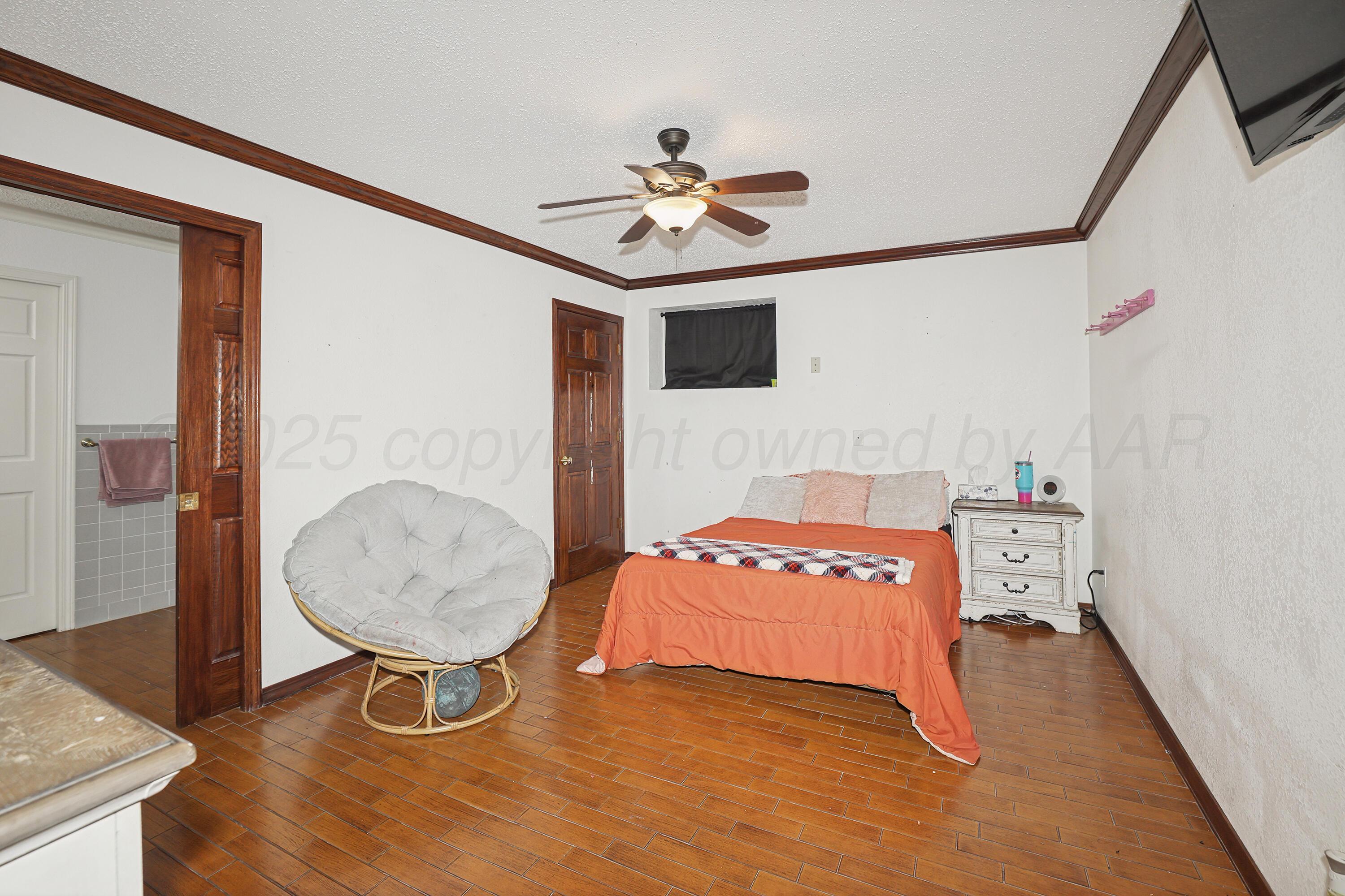 13901 Tangle Aire Point Amarillo, TX 79118 - Photo 28 of 55 a bedroom with a bed and a chandelier