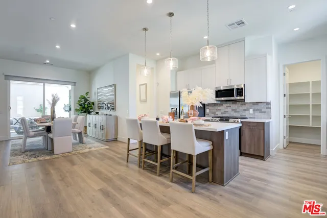 a large kitchen with a table and chairs