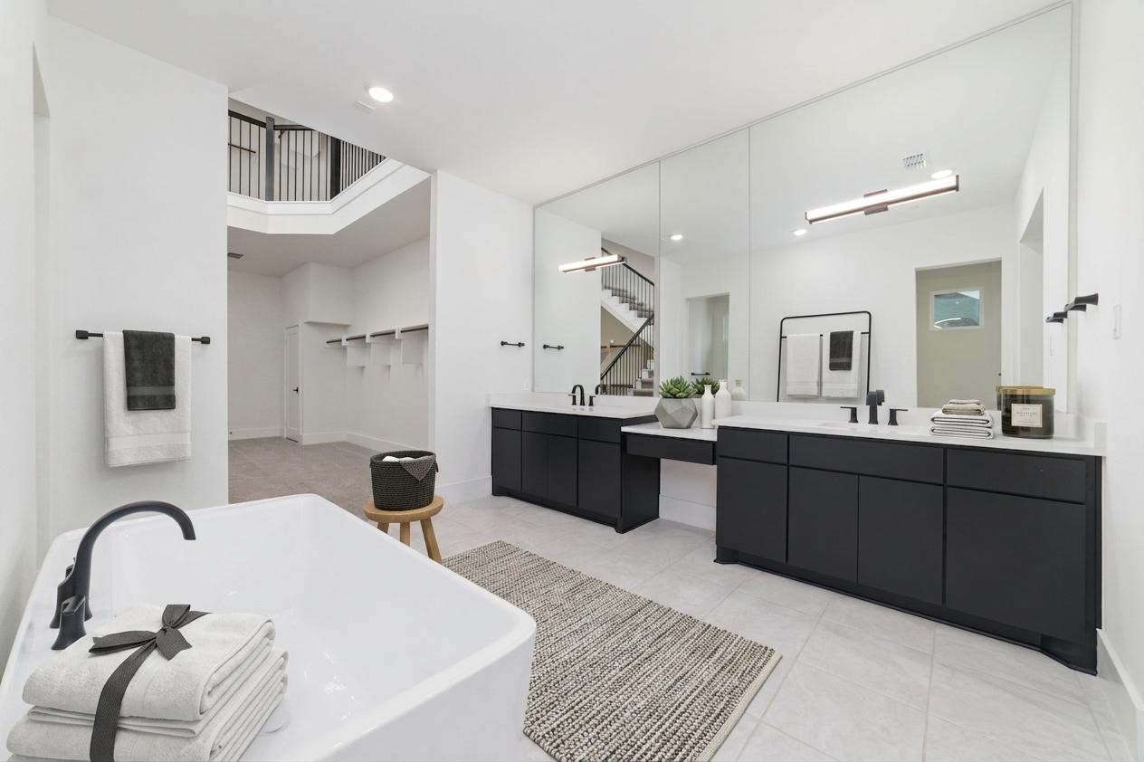 29627 Cir S Rnch Trail Fulshear, TX 77406 - Photo 21 of 50 Luxury lives in the details. Expansive dual vanities provide exceptional storage while giving everyone their own space to start and end the day. Luxury soaking tub and walk-in shower.