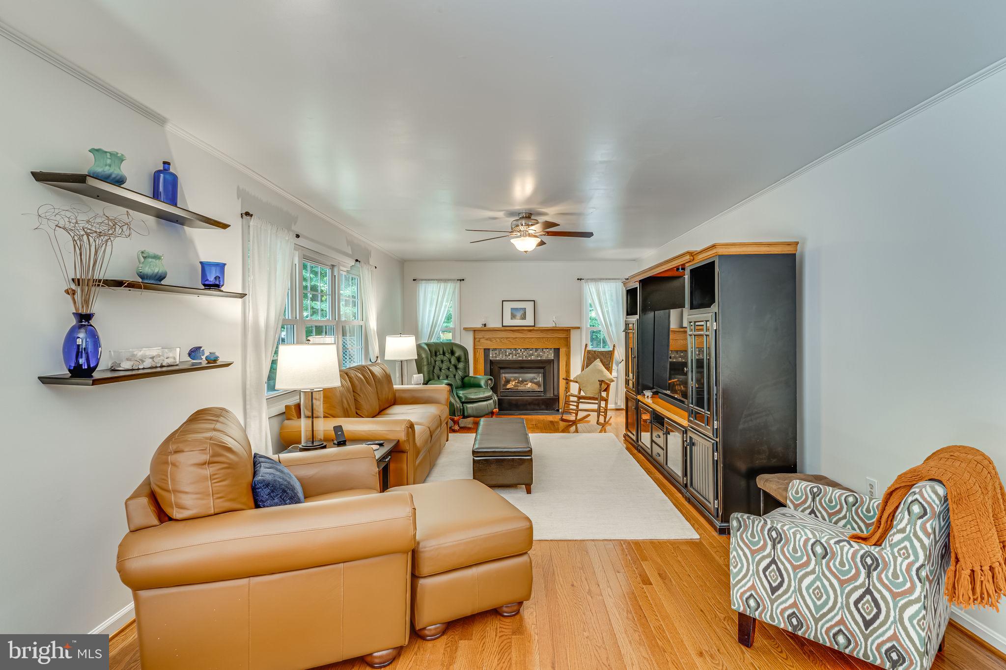 9741 Howes Road Dunkirk, MD 20754 - Photo 17 of 48 a living room with furniture fireplace and a flat screen tv