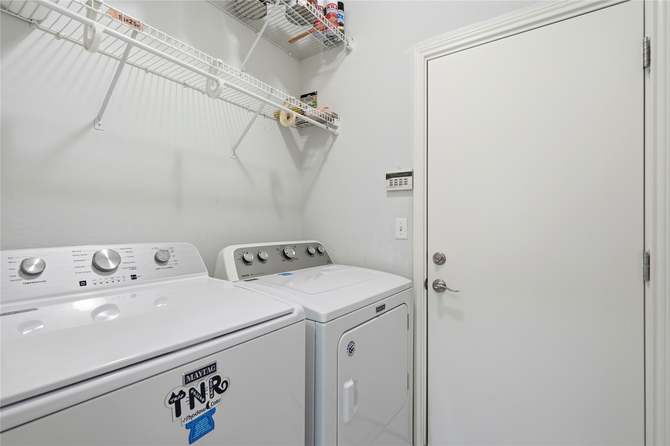 117 Whitewing Way Georgetown, TX 78633 - Photo 19 of 27 Functional laundry space with shelving for storage.