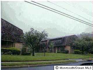 301 Spring Street, Unit 9 Red Bank, NJ 07701 - Photo 1 of 3 a view of a big building next to a yard