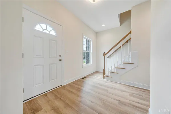 a view of entryway and hall with wooden floor
