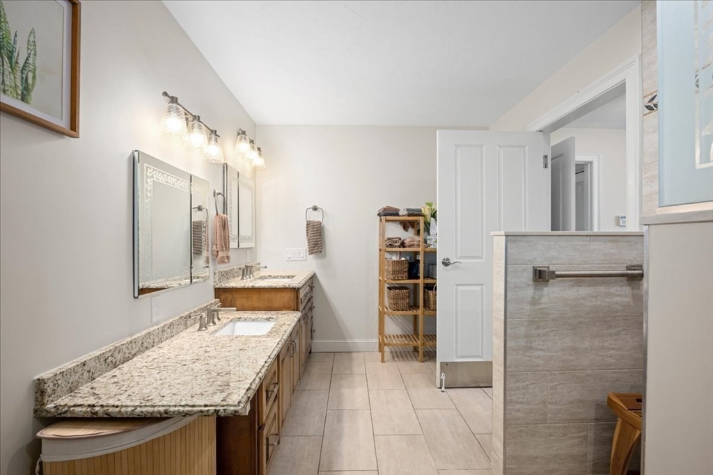 7 Primmett Lane, Unit 7 Worcester, MA 01609 - Photo 17 of 38 a bathroom with a granite countertop sink and a mirror