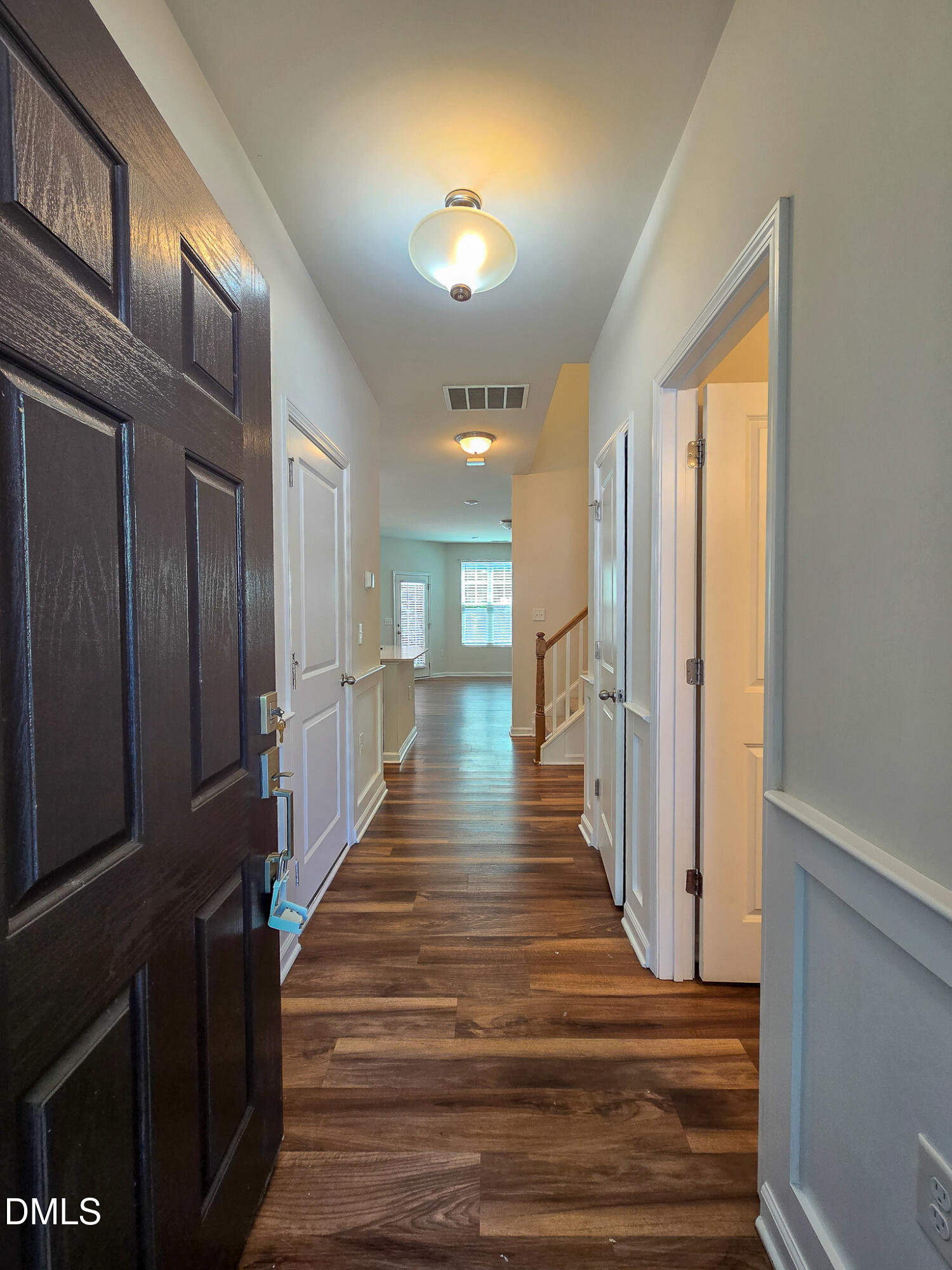 6145 Beale Loop Raleigh, NC 27616 - Photo 4 of 36 a view of a hallway with wooden floor and staircase