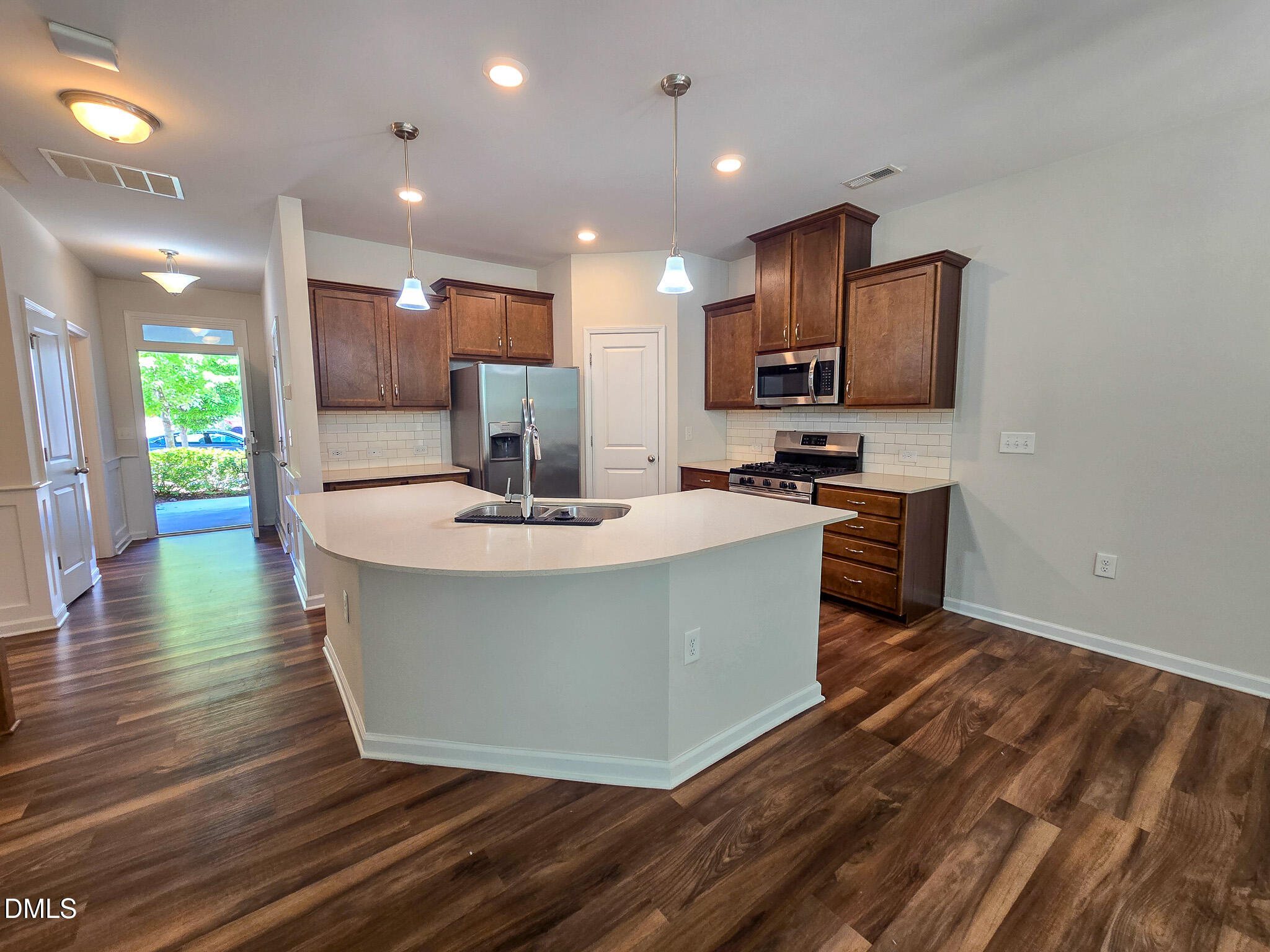 6145 Beale Loop Raleigh, NC 27616 - Photo 8 of 36 a view of kitchen with stainless steel appliances granite countertop a stove a sink a refrigerator and a microwave