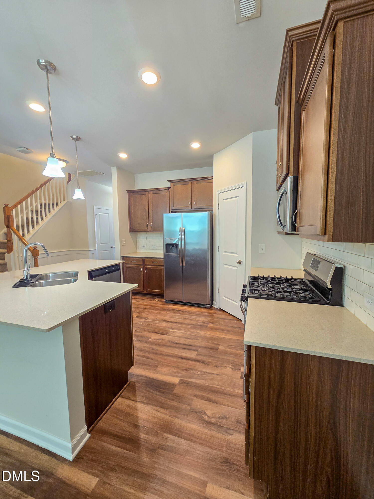 6145 Beale Loop Raleigh, NC 27616 - Photo 9 of 36 a kitchen with stainless steel appliances granite countertop a sink a stove and a refrigerator