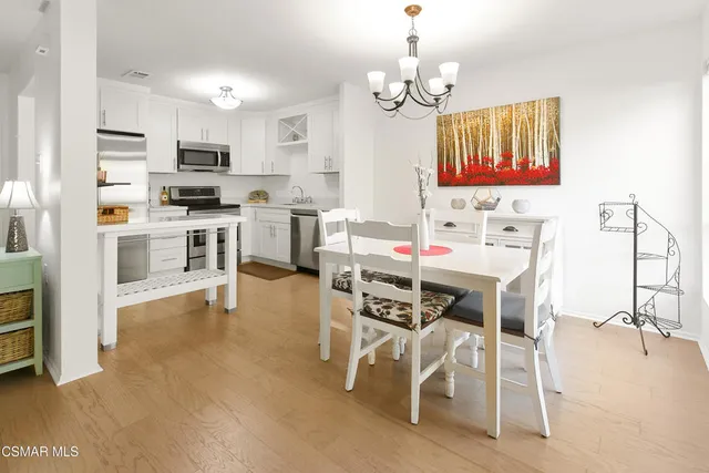 a view of kitchen with microwave and cabinets