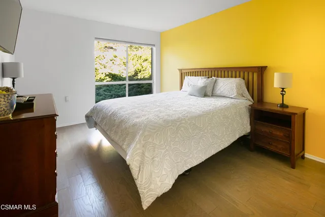 a bed sitting in a bedroom next to a window