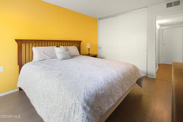 a large bed sitting in a bedroom next to a bathroom