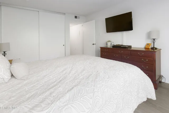 a room with a bed and a flat screen tv