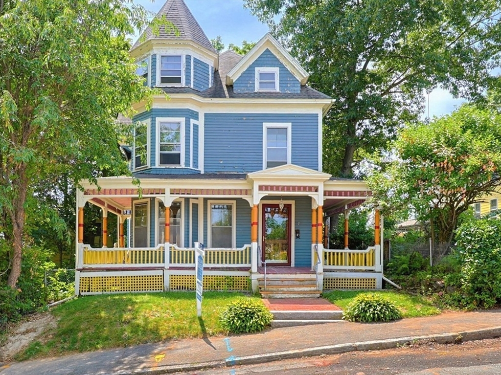 7 Baker Street Worcester, MA 01603 - Photo 1 of 42 a view of a white house with large windows and a large tree