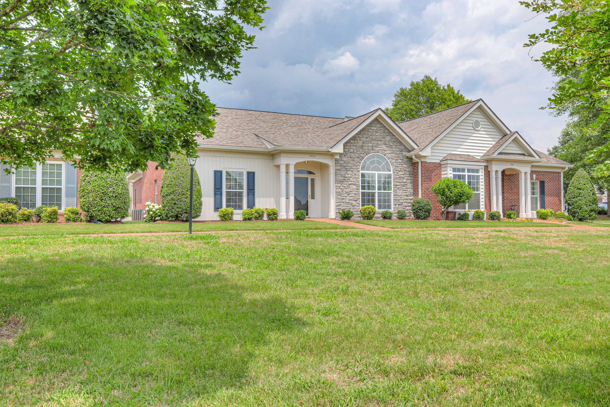a front view of house with yard and green space