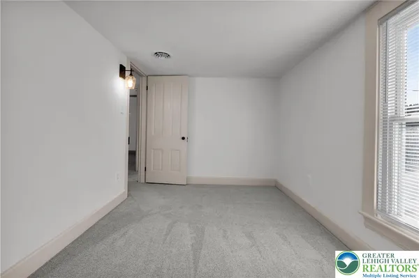 a view of an empty room with a window