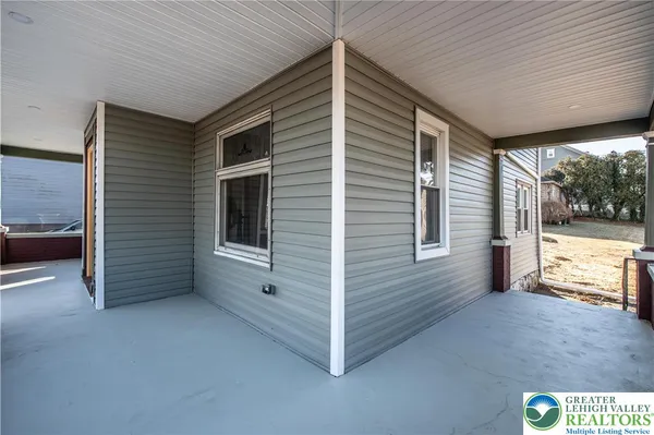 a view of a porch with wooden floor and roof