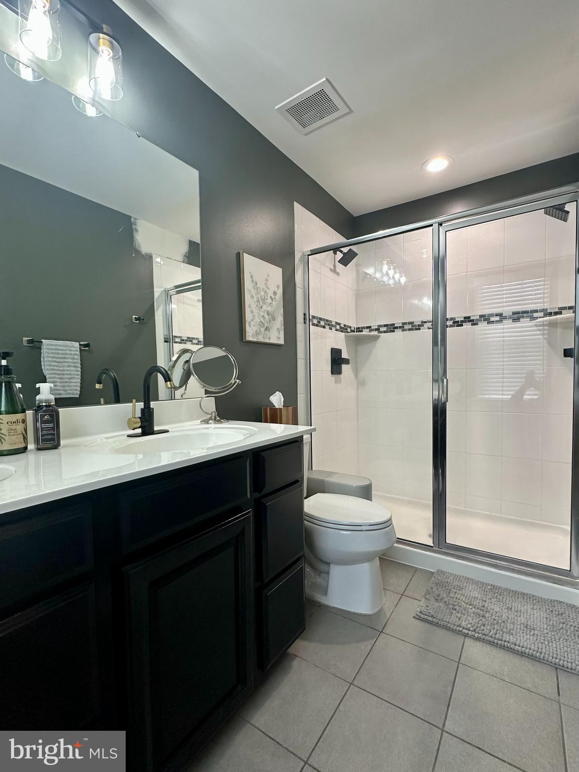 1043 Regency Place Sewell, NJ 08080 - Photo 14 of 24 a bathroom with a toilet sink double vanity and mirror
