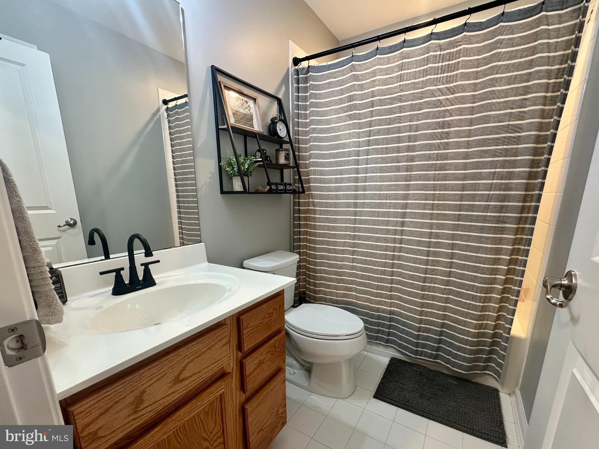 1043 Regency Place Sewell, NJ 08080 - Photo 20 of 24 a bathroom with a toilet sink and mirror