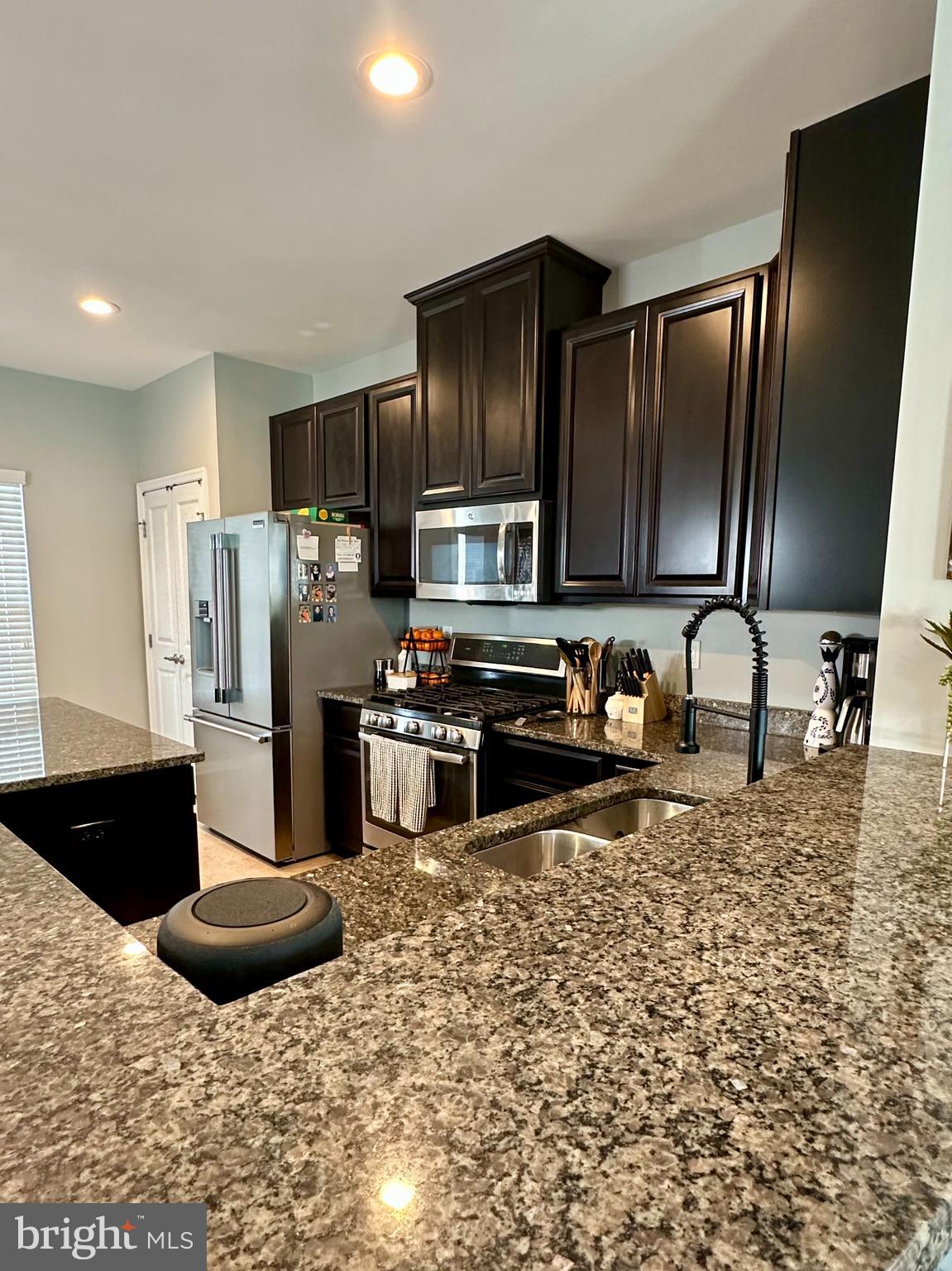 1043 Regency Place Sewell, NJ 08080 - Photo 6 of 24 a kitchen with stainless steel appliances granite countertop a refrigerator and a stove top oven