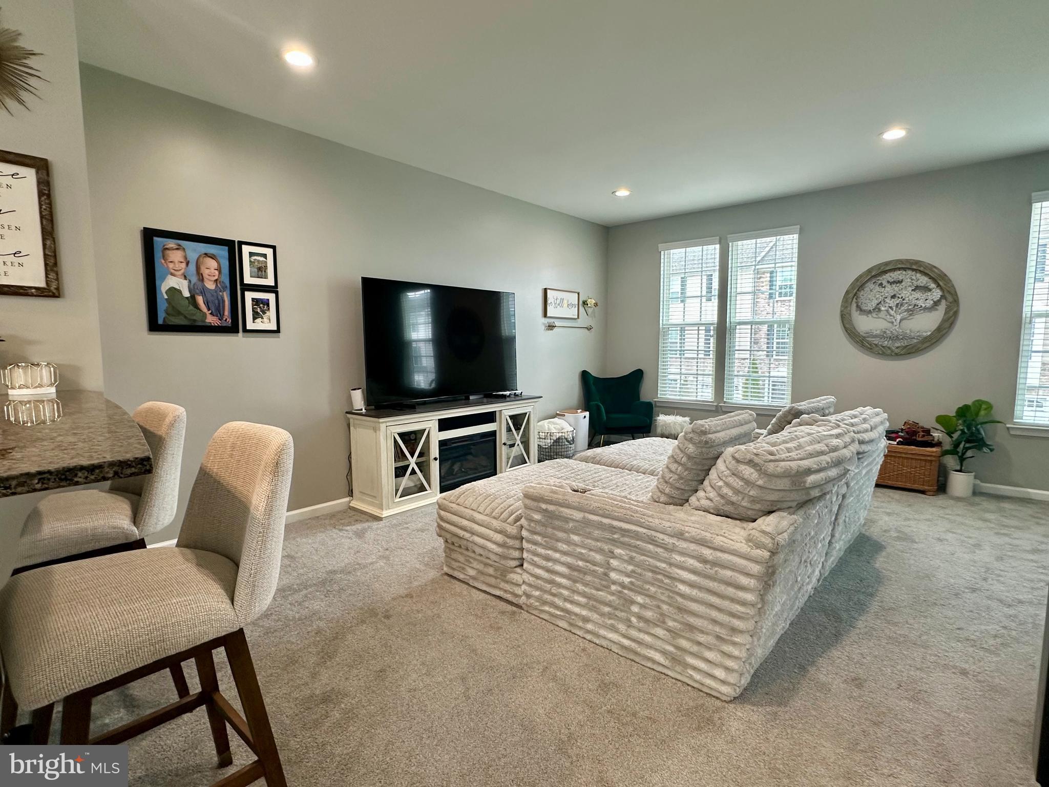 1043 Regency Place Sewell, NJ 08080 - Photo 9 of 24 a living room with furniture a flat screen tv and a large window
