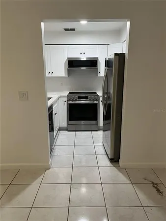 a kitchen with a stove top oven and cabinets