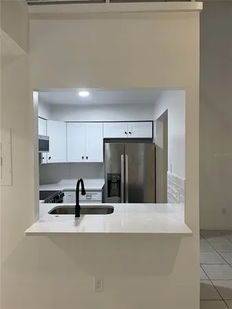 a view of a kitchen with a sink and cabinets
