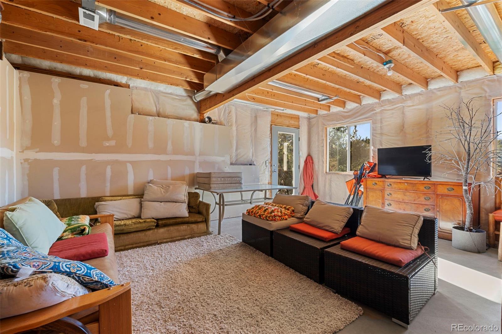 114 Hall Road Bailey, CO 80421 - Photo 15 of 21 a living room with furniture and a flat screen tv