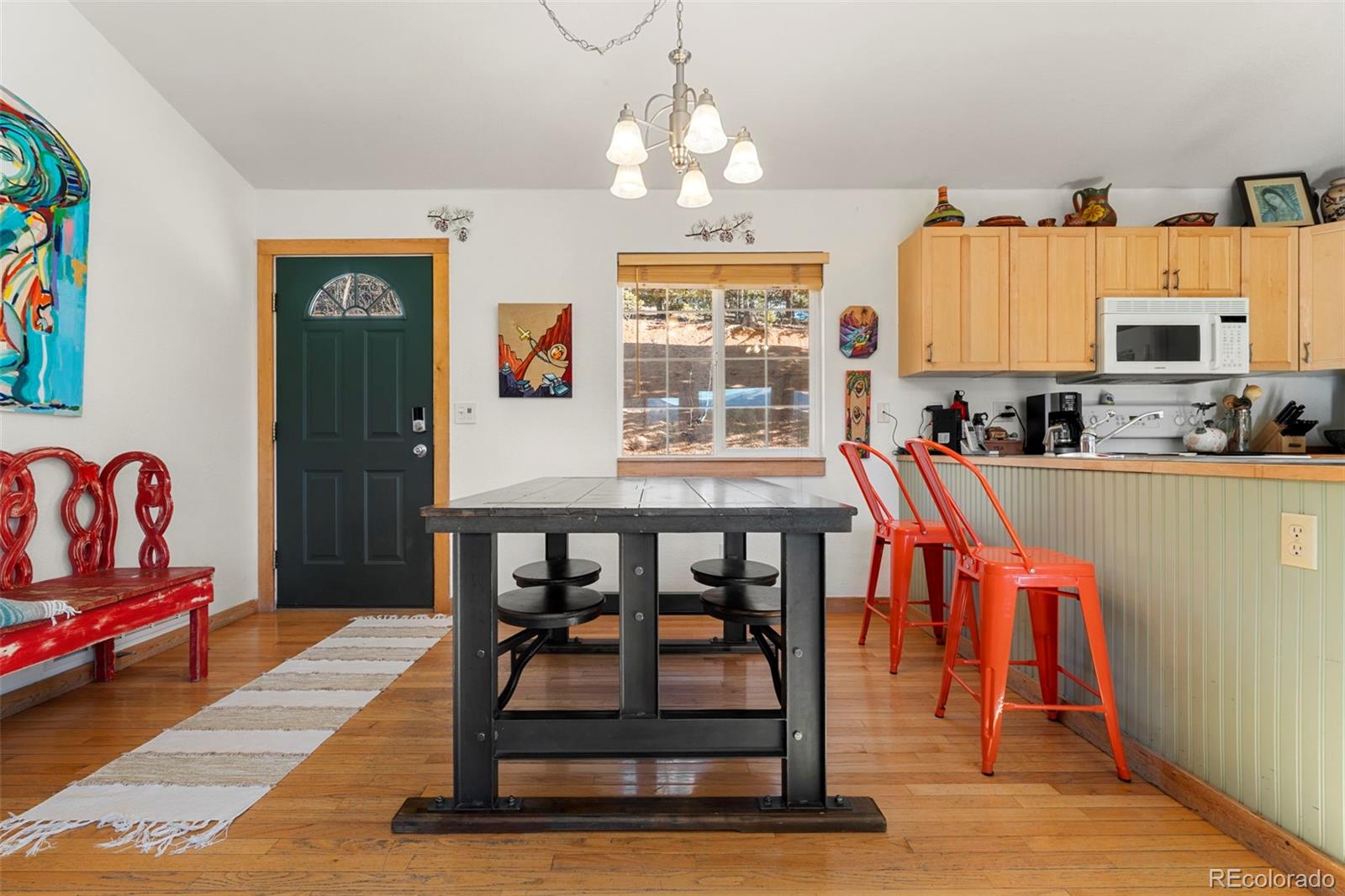 114 Hall Road Bailey, CO 80421 - Photo 6 of 21 a view of a dining room with furniture window and wooden floor