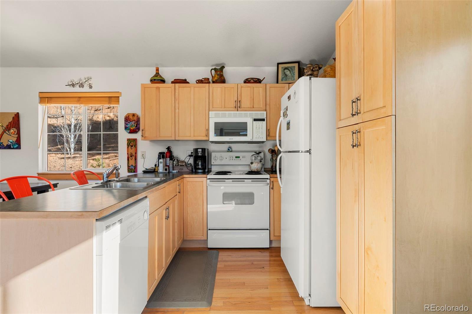 114 Hall Road Bailey, CO 80421 - Photo 7 of 21 a kitchen with stainless steel appliances a refrigerator sink and cabinets
