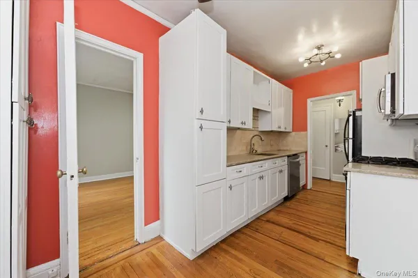 a kitchen with stainless steel appliances a refrigerator sink and cabinets