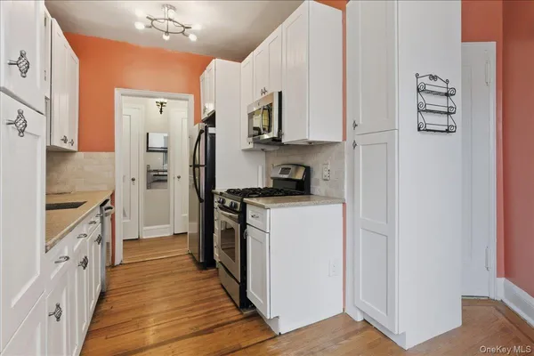 a kitchen with cabinets and stainless steel appliances