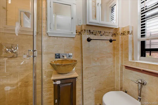 a bathroom with a shower a toilet and sink