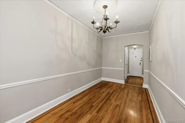 a view of a room with wooden floor and ceiling fan