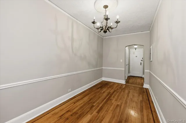 a view of a room with wooden floor and ceiling fan