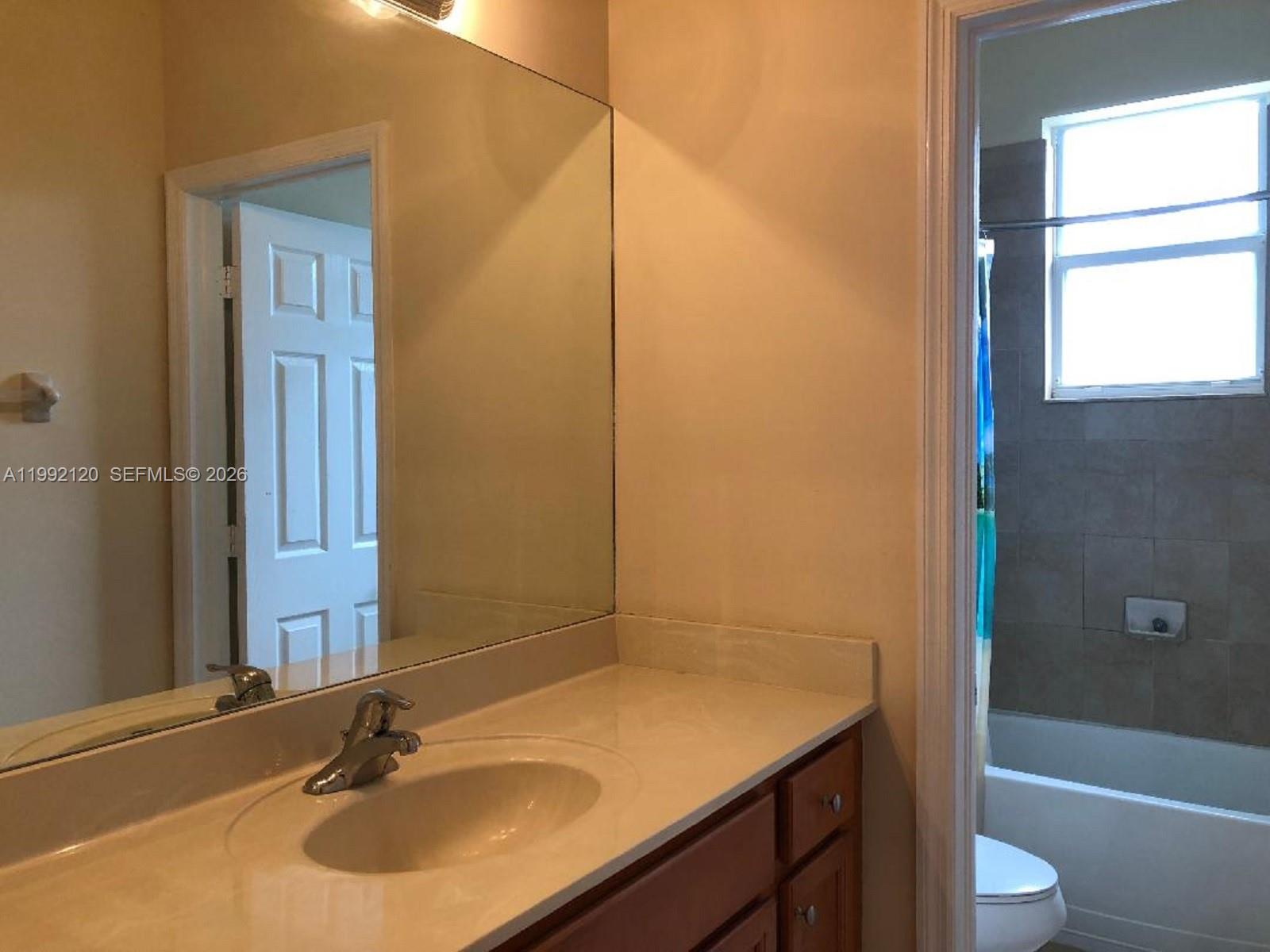 17000 Southwest 90th Terrace Miami, FL 33196 - Photo 18 of 56 a bathroom with a sink toilet vanity and shower