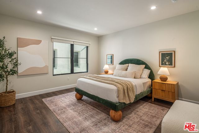 a spacious bedroom with a bed and a window