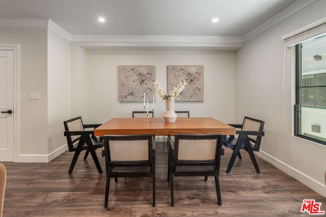 a dining room with furniture and wooden floor