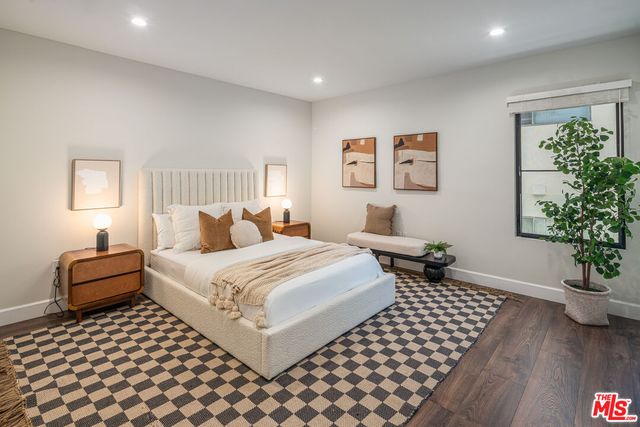 a bedroom with a bed and a potted plant