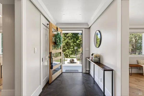 a kitchen with stainless steel appliances granite countertop a sink a stove a refrigerator and island with wooden floor