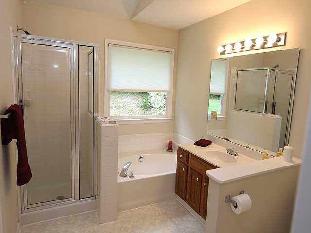 3605 Hopper Street Raleigh, NC 27616 - Photo 7 of 12 a bathroom with a tub sink and mirror