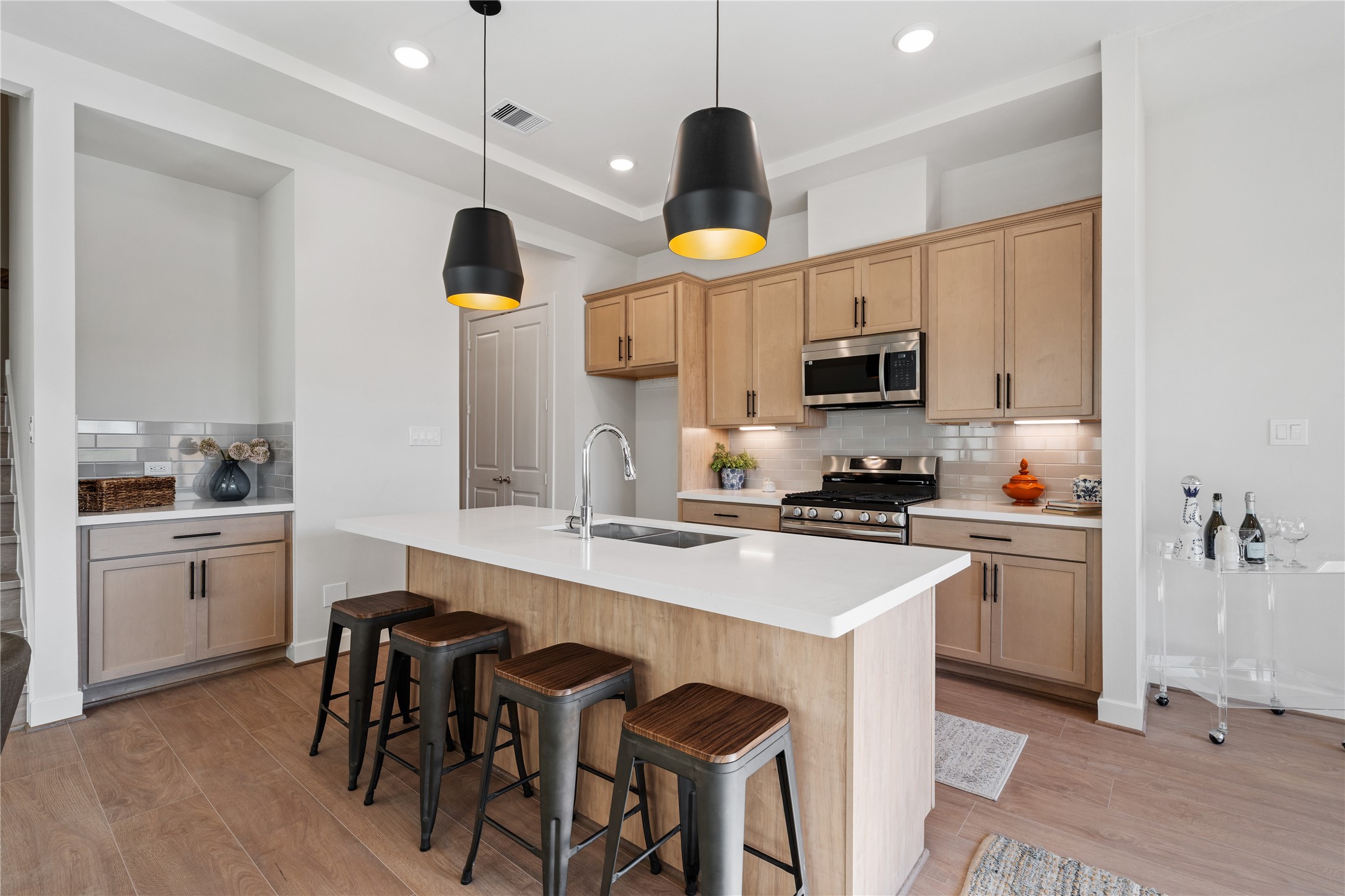 6505 Rena Street Houston, TX 77092 - Photo 8 of 28 A quartz island with built-in bar seating anchors the kitchen and gives the space a natural gathering point beyond just cooking.
