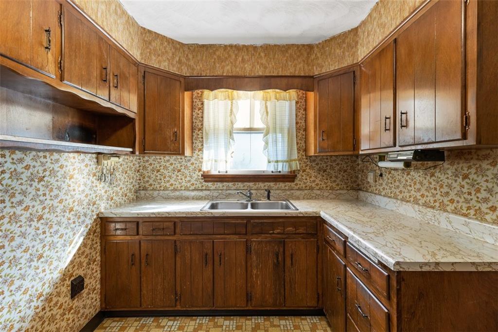 1645 Charlton Heights Road Coraopolis, PA 15108 - Photo 11 of 49 a kitchen with granite countertop a sink a stove and cabinets