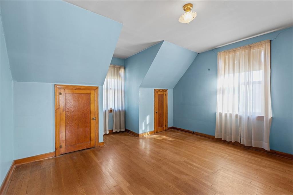 1645 Charlton Heights Road Coraopolis, PA 15108 - Photo 22 of 49 an empty room with wooden floor and windows