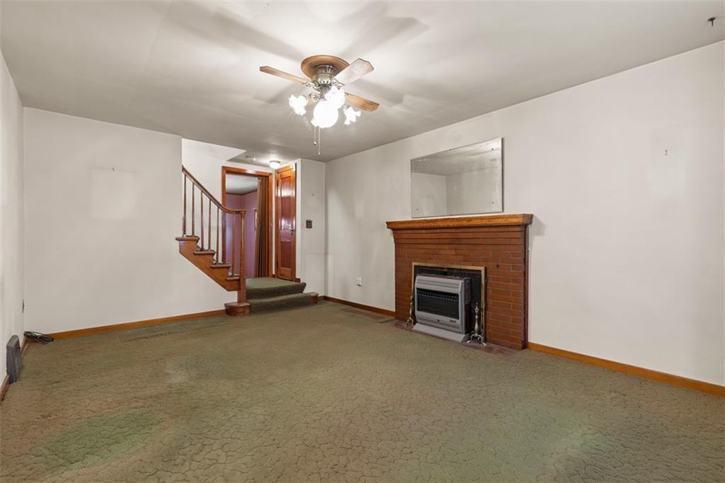 1645 Charlton Heights Road Coraopolis, PA 15108 - Photo 5 of 49 a view of an empty room with chandelier fan and fire place