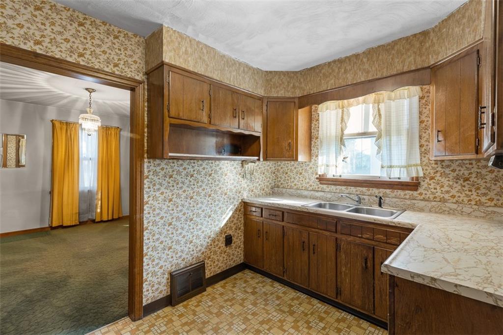 1645 Charlton Heights Road Coraopolis, PA 15108 - Photo 10 of 49 a kitchen with stainless steel appliances granite countertop a sink stove and cabinets
