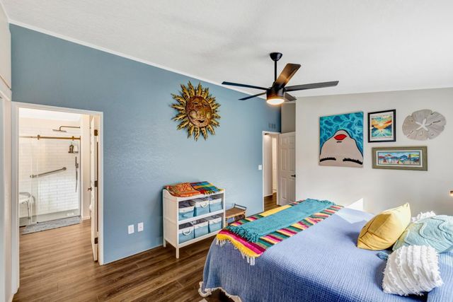 a bedroom with a bed and a wooden floor