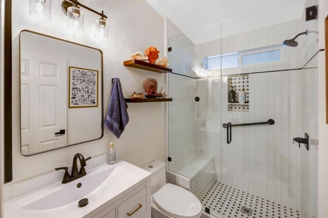 a bathroom with a sink toilet and shower